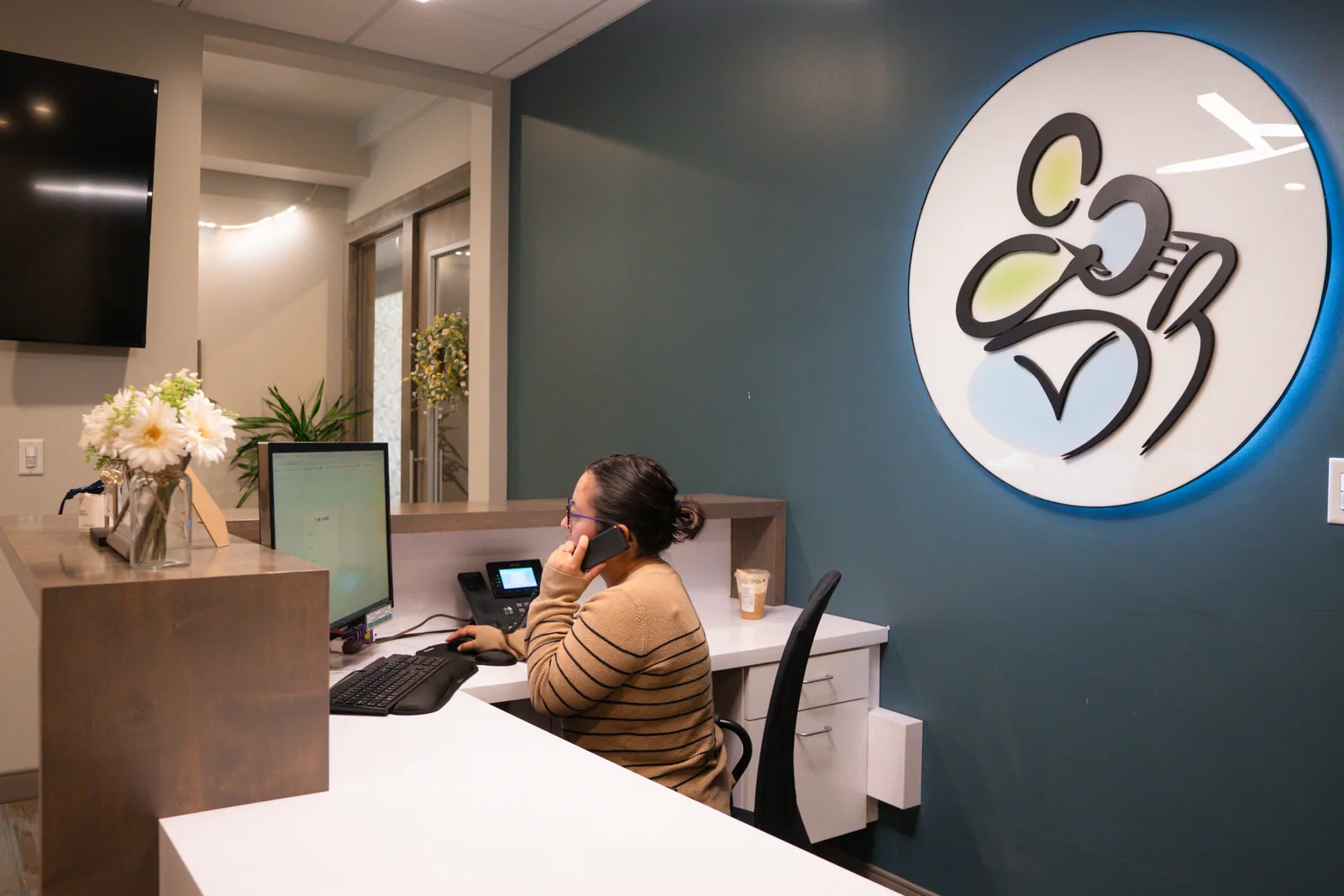 A front desk team member scheduling appointments at Marconi Dental Group